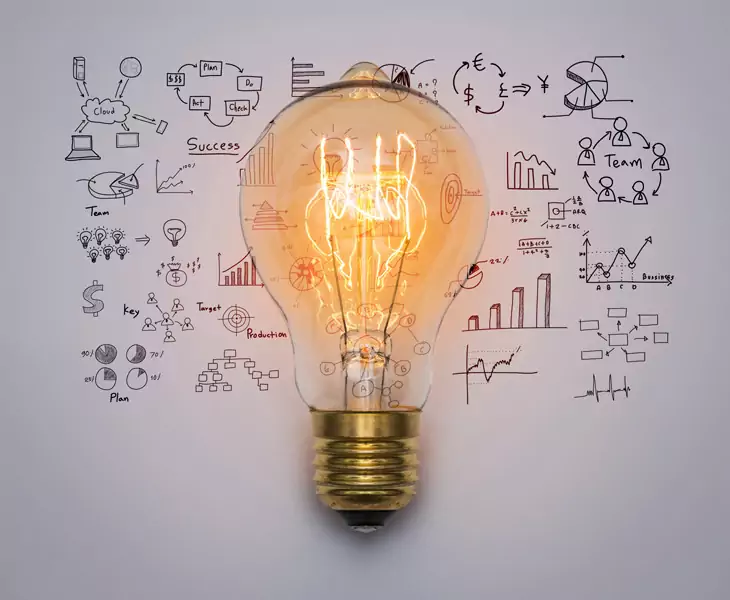 Lightbulb surrounded by business strategy sketches