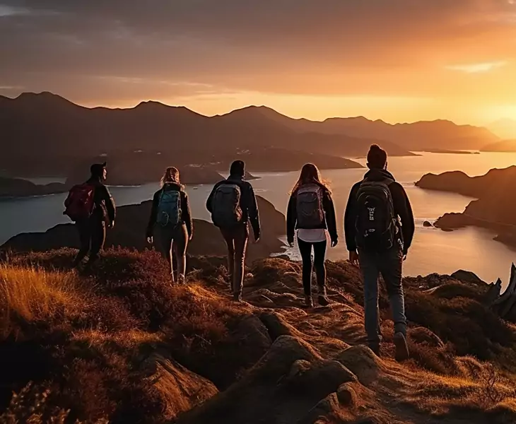 Adventurous team hiking together at sunset